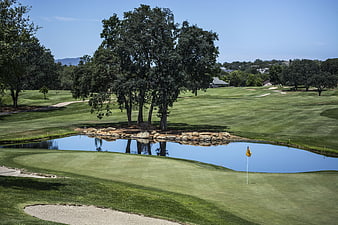 Serene Golf Course with Water Hazard and Flag