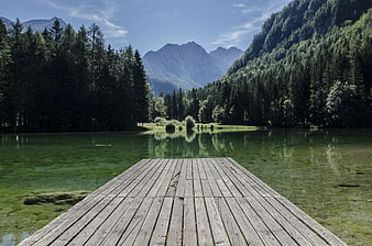 Wooden Dock on Alpine Lake with Mountain Reflections