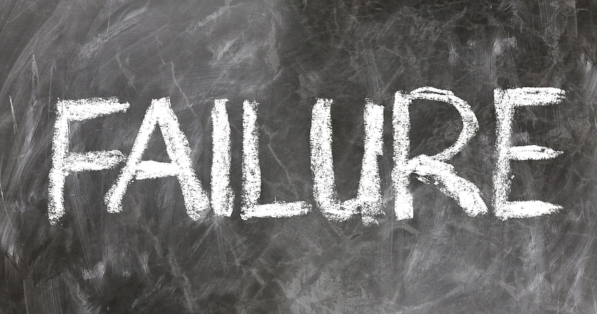 The word failure written in white chalk on a dark blackboard