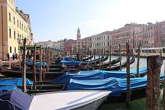 Gondolas moored along a Venetian canal with historic architecture