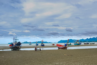 Colorful Fishing Boats on Sandy Beach at Low Tide