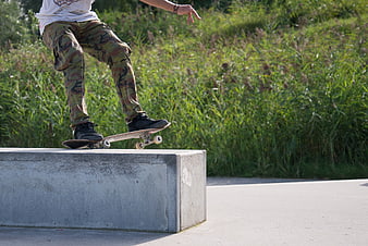 Skateboarder Grinding on Concrete Block
