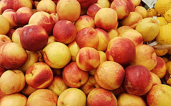 Fresh Ripe Peaches Piled in Market Display