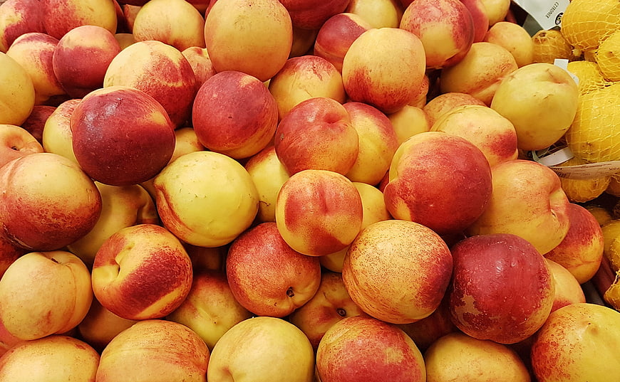 Fresh Ripe Peaches Piled in Market Display