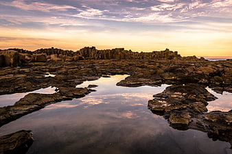 Dramatic Sunset Reflection on Rocky Coastal Tide Pools