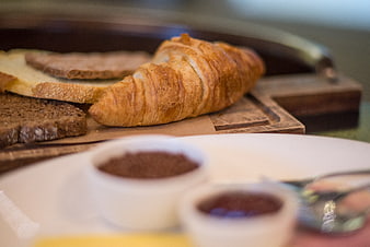 Golden Croissant and Bread on Wooden Board with Jam
