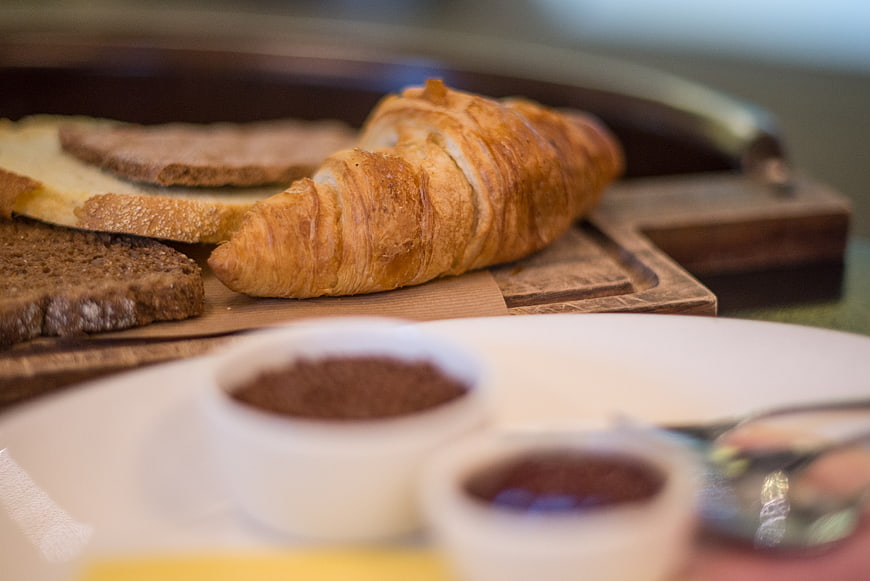 Golden Croissant and Bread on Wooden Board with Jam