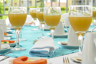 Elegant Table Setting with Orange Juice and Fresh Fruit