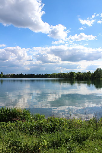 Serene Lake Landscape with Blue Sky and Cloud Reflections