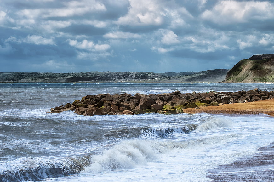 Dramatic Seascape with Rocky Breakwater and Crashing Waves