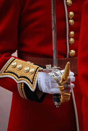 Close-up of Royal Guard in Red Uniform Holding Silver Saber