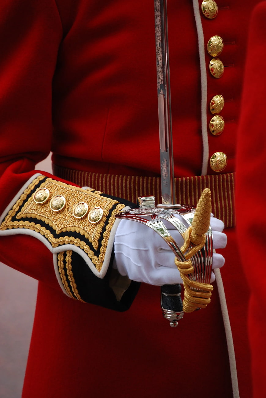 Close-up of Royal Guard in Red Uniform Holding Silver Saber