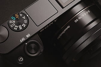 Close-up of black Sony mirrorless camera top dial and lens