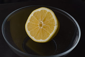 Sliced Lemon on Dark Plate