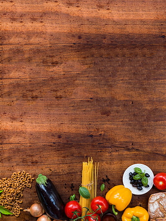Italian pasta ingredients on rustic wooden table with copyspace