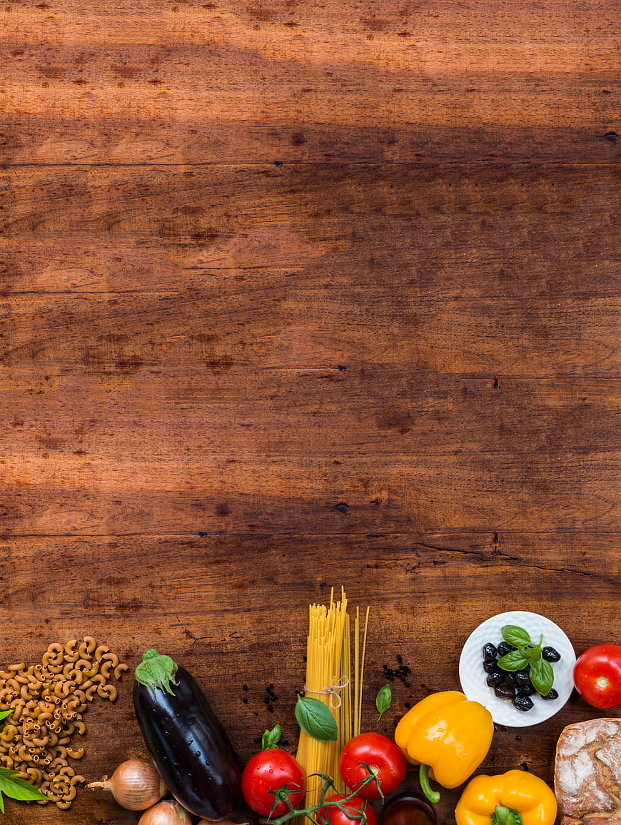 Italian pasta ingredients on rustic wooden table with copyspace