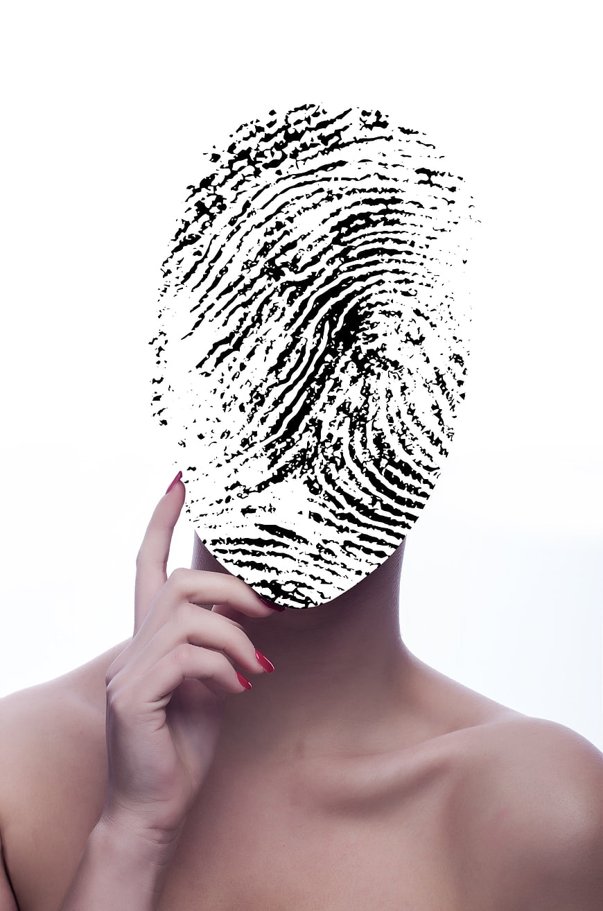 Conceptual woman with fingerprint face symbolizing identity and data security