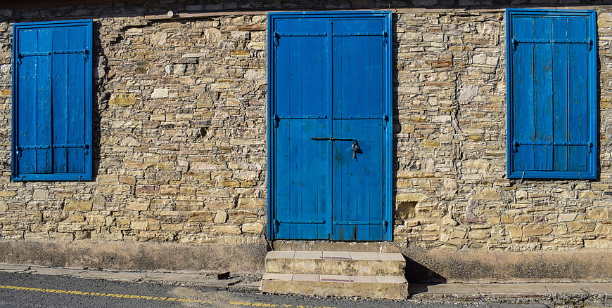 Traditional Stone House with Blue Door and Shutters
