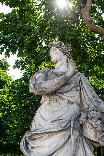 Classical Marble Statue in Sunlit Garden