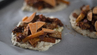 Uncooked mini pizzas with sweet potato and meat toppings