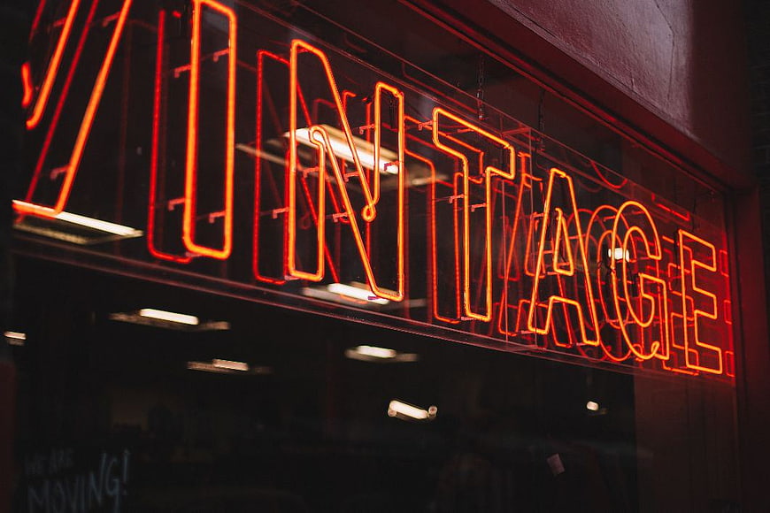 Red Vintage Neon Sign in Dark Storefront Window