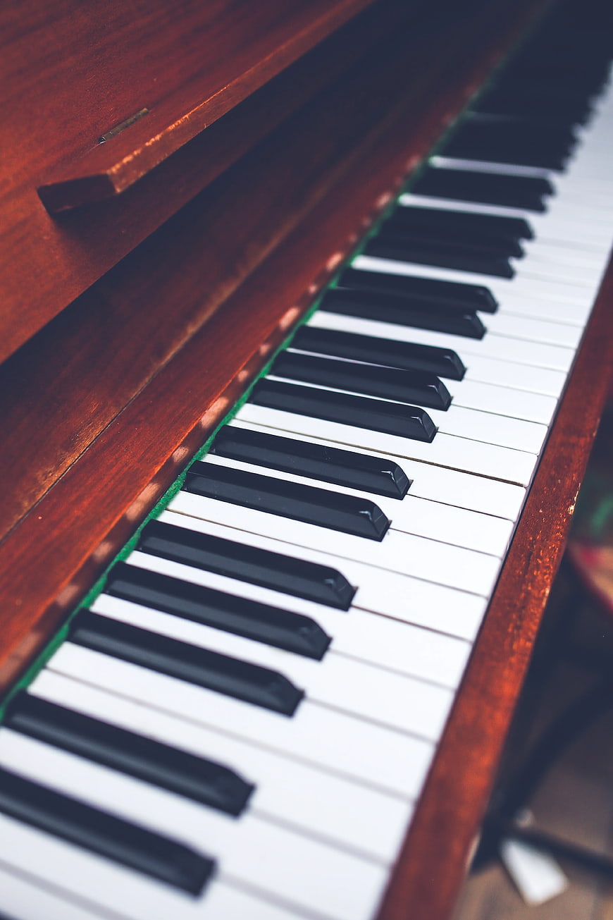 Close-up of vintage piano keys with wooden frame