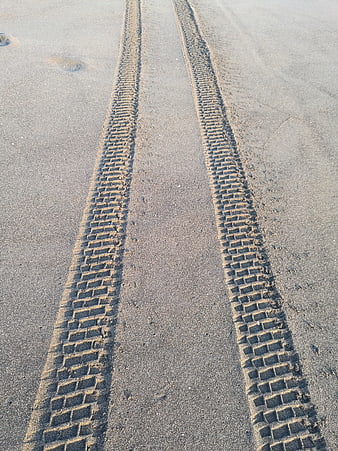 Tire tracks in sand on a beach