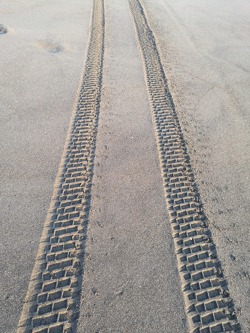 Tire tracks in sand on a beach