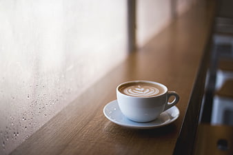 Latte Art Coffee Cup on Wooden Window Sill