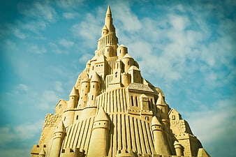 Intricate Sand Castle Sculpture Against Blue Sky