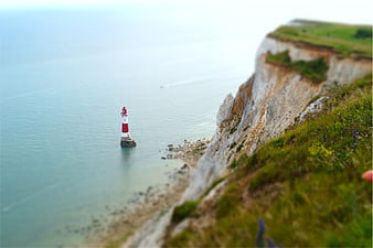 Tilt-shift lighthouse on white cliffs by the sea