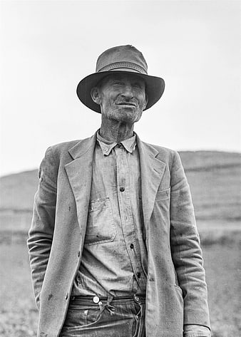Vintage Black and White Portrait of Weathered Man in Hat