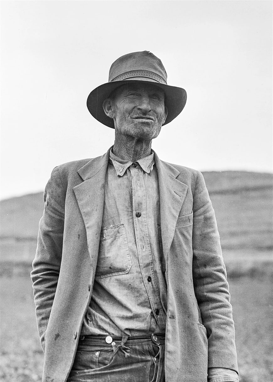 Vintage Black and White Portrait of Weathered Man in Hat