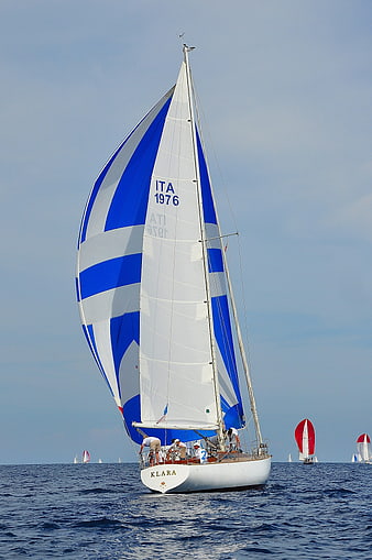 Classic Sailing Yacht Klara With Blue And White Striped Sails On Open Sea