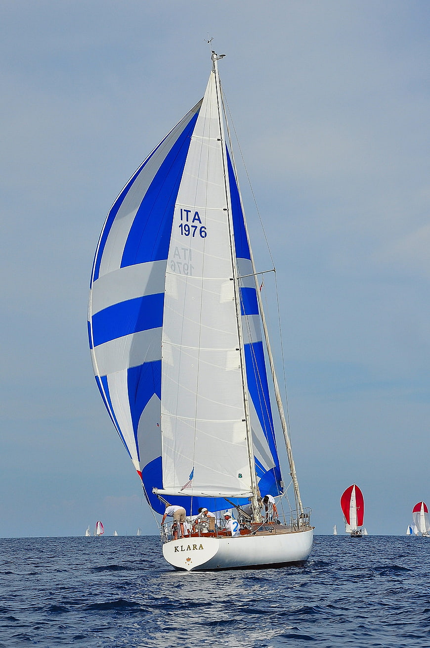 Classic Sailing Yacht Klara With Blue And White Striped Sails On Open Sea