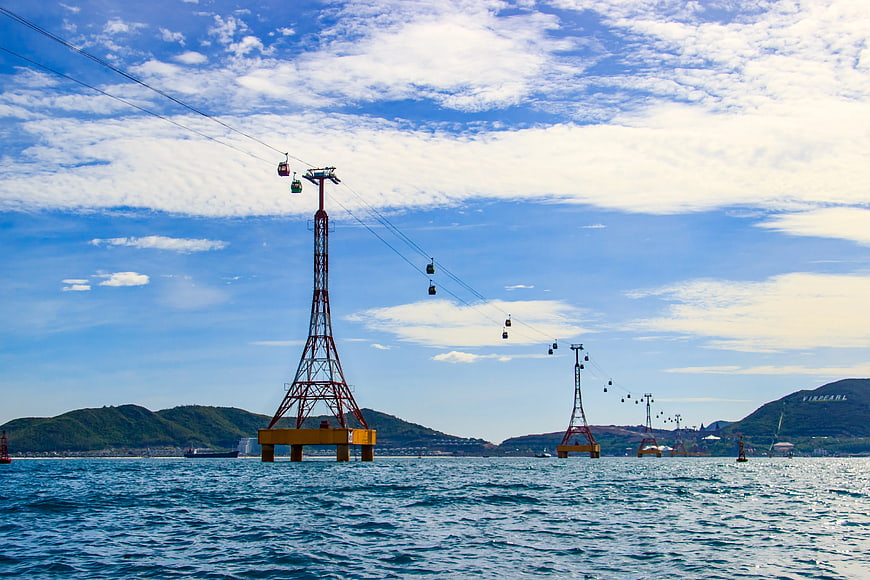 Yellow Cable Car Towers Spanning Blue Ocean Water