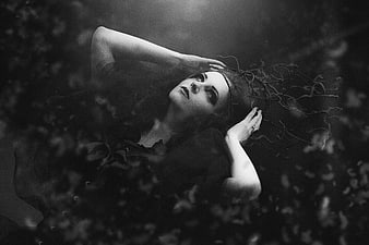 Gothic woman with dark makeup and vine crown in black and white