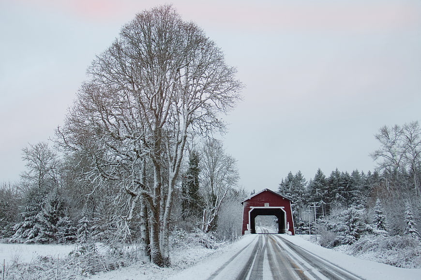 Red Covered Bridge on Snowy Winter Road