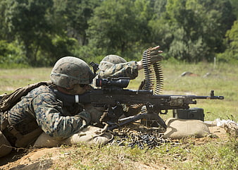 Marines firing machine gun during military training exercise