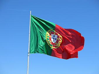 Portugal National Flag Waving Against Clear Blue Sky