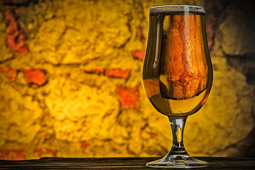 Chilled Glass of Amber Beer on Wooden Table