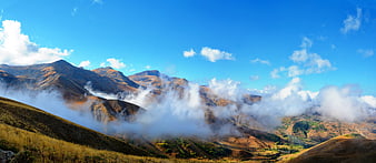 Panoramic Mountain Landscape with Mist and Blue Sky