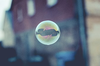 Soap Bubble Reflecting Cityscape with Iridescent Colors