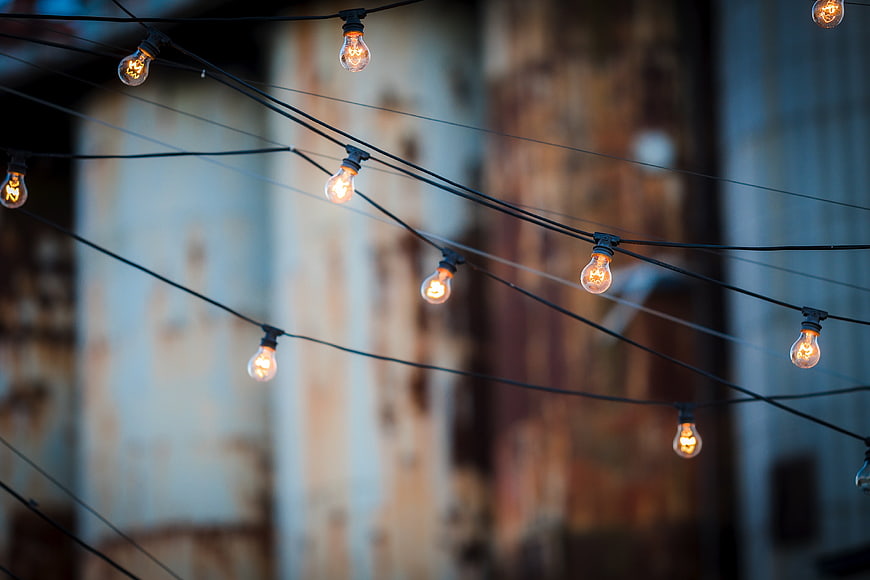 Glowing Edison Bulb String Lights Against Blurred Background