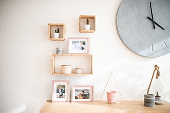 Minimalist Home Decor with Wooden Shelves and Pink Frames