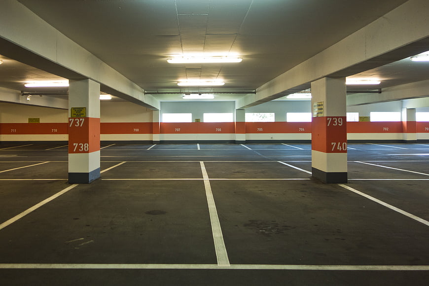 Empty Multi-Storey Parking Garage Interior With Numbered Concrete Pillars