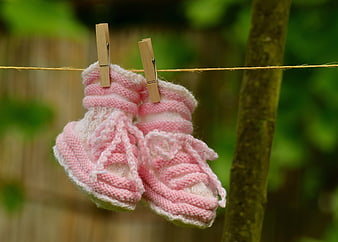Pink Knitted Baby Booties Hanging on Clothesline