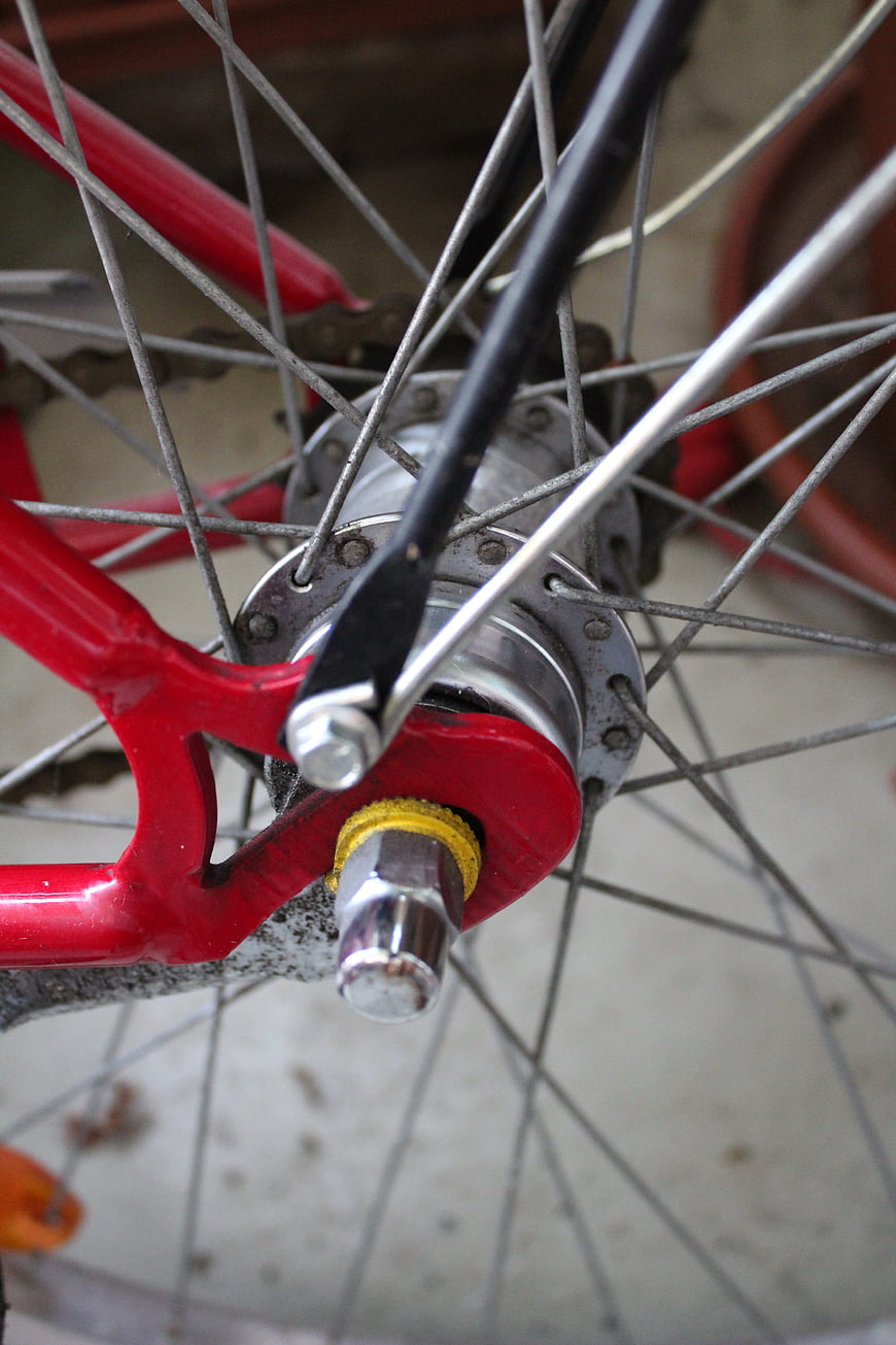 Close-up of red bicycle rear wheel hub and spokes