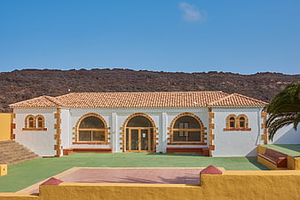 White building with terracotta roof and arched windows in Fuerteventura