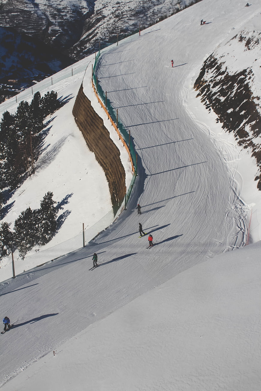 High Angle View of Skiers on Snowy Mountain Slope